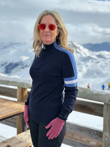  Woman wearing Snow Finel Ski Jumper Nvy and blue and white stripes in snow background