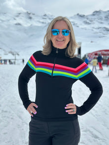  Person wearing a black sweater with colorful stripes in a snowy landscape
