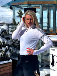  chemmy alcott wearing  white merino ski jumper with pattern on sleeve and chest 