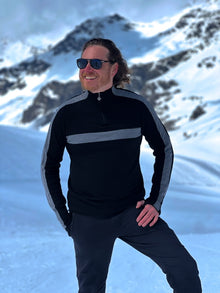  man wearing black and grey merino jumper in the snow